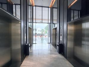 an empty hallway in a building with doors open at Vetro11 Kota Kinabalu by LAXZONE in Kota Kinabalu