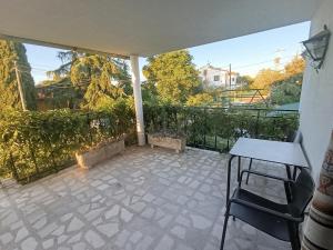 a patio with a table and chairs on a balcony at La Casa de mi Abuela in El Viso de San Juan