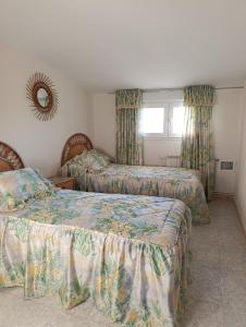 a bedroom with two beds and a window at La Casa de mi Abuela in El Viso de San Juan +66 photos