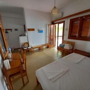 a bedroom with a bed and a table and chairs at Stelios in Agia Galini