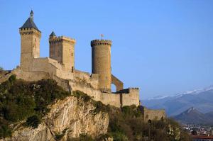 a castle sitting on top of a mountain at Camping du Lac in Foix