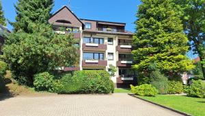 a large apartment building with trees in front of it at Ferienwohnung Harzwiese in Bad Sachsa