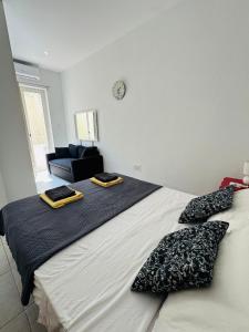 a bedroom with a large bed with two pillows on it at Central and Modern Apartment St Julians in St Julian's +10 photos