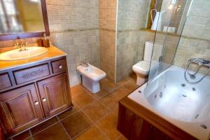 un bagno con vasca, lavandino e WC di Apartament familiar de luxe i balcó amb vistes by RURAL D'ÀNEU a València d'Àneu
