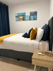 a bedroom with a bed with pillows and a table at Exclusive Two Bedrooms Presidential Suite in Coral Point in Sibaya +29 photos