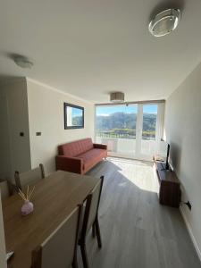 a living room with a couch and a table at Hermoso departamento nuevo en Concepción 3 in Concepción