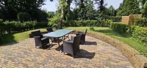 a table and chairs on a brick patio at De tepelenburg in Harskamp