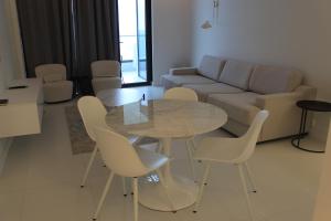 a living room with a table and chairs and a couch at Bamboo Tsikhisdziri Apartment in K'obulet'i