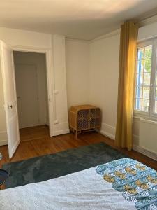 an empty room with a bed and a window at Le Parfait in Beauvais