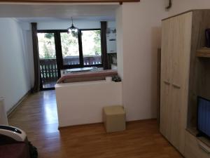 a living room with a bed and a television at Sofia Caffee Apart in Poiana Brasov +4 photos
