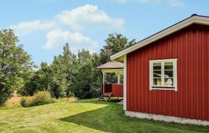 a red house with a gazebo in a yard at 2 Bedroom Gorgeous Home In Broaryd in Broaryd