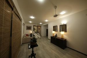 a hallway with two tables and two lights on the wall at Seilan in Colombo