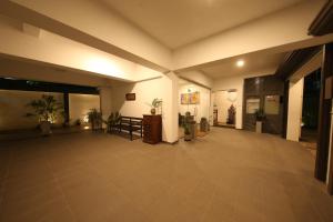 an empty lobby with a table and potted plants at Seilan in Colombo