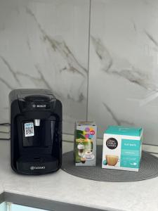 a black coffee maker and a box on a counter at House Elisa in Sighetu Marmaţiei +3 photos