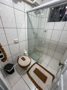a bathroom with a shower with a toilet and a sink at Hospedagem Doce lar in Joinville