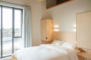 Ένα ή περισσότερα κρεβάτια σε δωμάτιο στο Une chambre à l'Economat