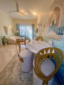 a living room with a table and chairs and a couch at Amenti House - Private Villa & Retreat Center in Luxor