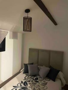 a bedroom with a bed with a chandelier at Casa del campo in Souani