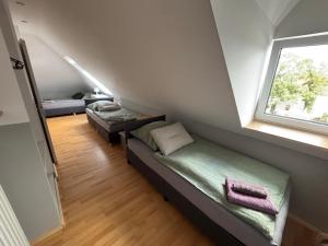 a small room with a bed and a window at Zimmer für 3 Personen, Kühlschrank-Bad in Meine