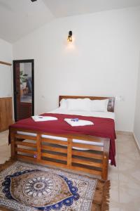 a bedroom with a bed with a red blanket on it at The Beach Hive in Kappil
