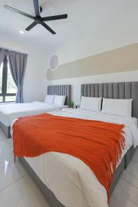 two beds in a bedroom with a ceiling fan at Cameron Centrum JoyStay Kids Fun Zone Clover Home A-2-15 A in Brinchang