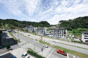 an aerial view of a city with buildings and a street at Cameron Centrum JoyStay Kids Fun Zone Clover Home A-2-15 A in Brinchang