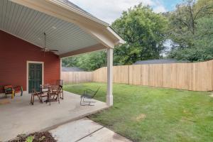 a patio with a table and chairs and a fence at Higbee House Too, AKA The Jolly Roger in Memphis
