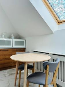 a kitchen with a table and two chairs at Strzyzewo Witkowskie Luxury Apartment in Strzyżewo Witkowskie