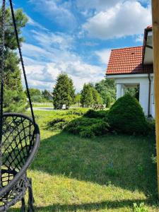 a swing in a yard next to a house at Strzyzewo Witkowskie Luxury Apartment in Strzyżewo Witkowskie