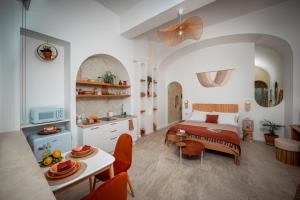 a bedroom with a bed and a table with chairs at Arcu Retreat in Positano