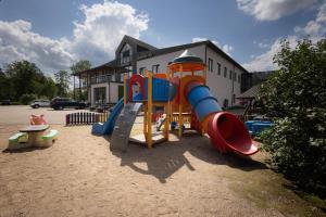 a playground with a slide and a slideintend at Hotel SPA Arkadia in Apšuciems