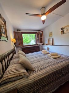 a large bed with two pillows on it in a room at Rural Kairós "Un espacio con alma" in Siete Aguas +70 photos