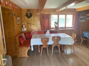 a dining room with a table and two chairs at Relais de Van d'en Haut in Salvan +9 photos