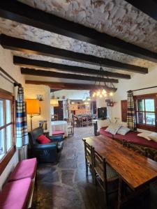 a living room with a couch and a table at Rural Kairós "Un espacio con alma" in Siete Aguas