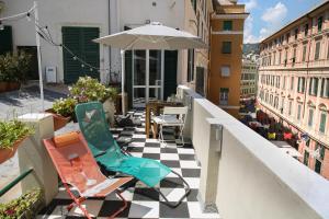 een patio met stoelen en een parasol op een balkon bij La Genova storica dal monolocale in Genua