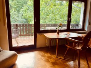 a room with a table and two large windows at Odw homes - Wohnung im Landhaus mit Garten in Trösel