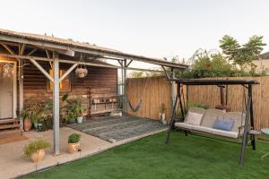 a patio with a gazebo in a backyard at בקתת המפל הלבן in Eli Ad