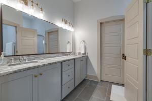 a bathroom with two sinks and a large mirror at Higbee House Too, AKA The Jolly Roger in Memphis +34 photos