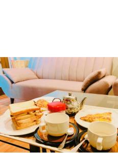a coffee table with plates of food on it at Majestic Family Lodges in Islamabad