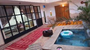 a room with a swimming pool in a house at Riad Laila Marrakech in Marrakesh