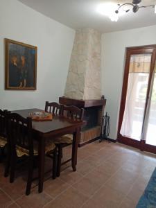 a dining room with a table and a fireplace at Luna Reale Roccaraso apt in Roccaraso