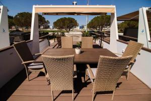 a wooden table and chairs on a rooftop deck at Luxury Houseboat Lavender in Portorož +9 photos