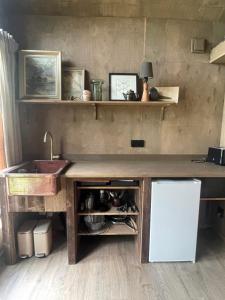a kitchen with a counter with a sink and a counter sidx sidx at The Nest bed and garden in Varberg