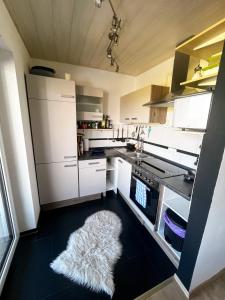 a kitchen with white appliances and a rug on the floor at Apartment Mary Mehlmeisel in Mehlmeisel +35 photos