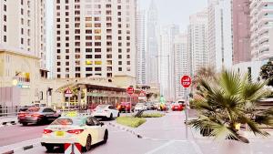 a busy city street with cars parked on the road at JBR Studio Apartment - Bay Central in Dubai +4 photos