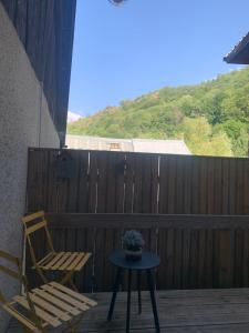 a patio with a chair and a table and a chair at Appartement Le Ponteil in Les Deux Alpes