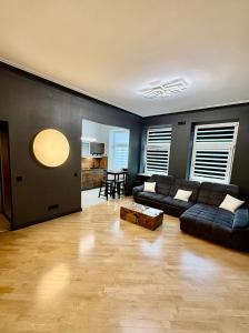 a living room with a couch and a table at Downtown Kaunas - Maironis 10 in Kaunas