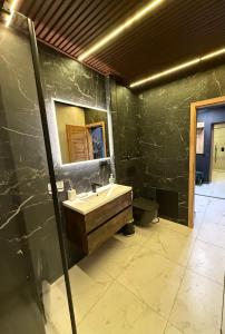 a bathroom with a sink and a mirror at Downtown Kaunas - Maironis 10 in Kaunas