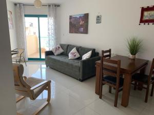 a living room with a couch and a table at נופש במגדלי המלכים in Tiberias