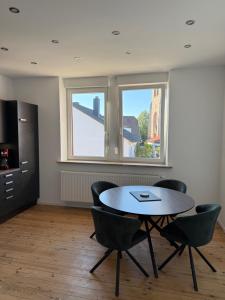 a room with a table and chairs and a window at Ferienwohnung Hildegard in Clausen